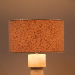 Loam Table Lamp, close view of textured fabric shade on a marble base against a brown background