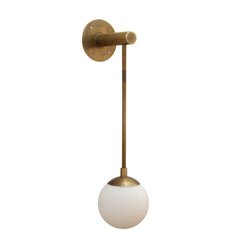 Wall-mounted light fixture with brass finish and white glass shade on a white background