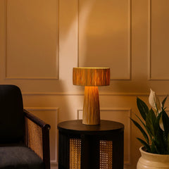 Decorative Fiume table lamp made of metal frame encased in natural raffia on a side table