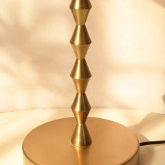 Gold geometric rod for Lumo Table Lamp on a neutral background