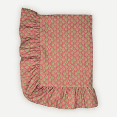 Viola Ruffle Carmine Cotton Table Cover laid flat, floral buti print with gathered ruffle border