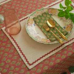 Viola Ruffle Carmine Cotton Table Cover with placemat, floral plate and green napkin, top view