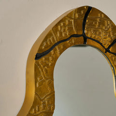Gold decorative wall mirror with a textured border made of aluminum, close view
