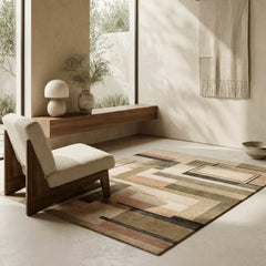 Modern interior with a patterned rug, wooden chair, and decorative items.