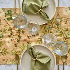 Valley Peach Linen Table Runner with plates, green napkins and gold napkin rings, top view
