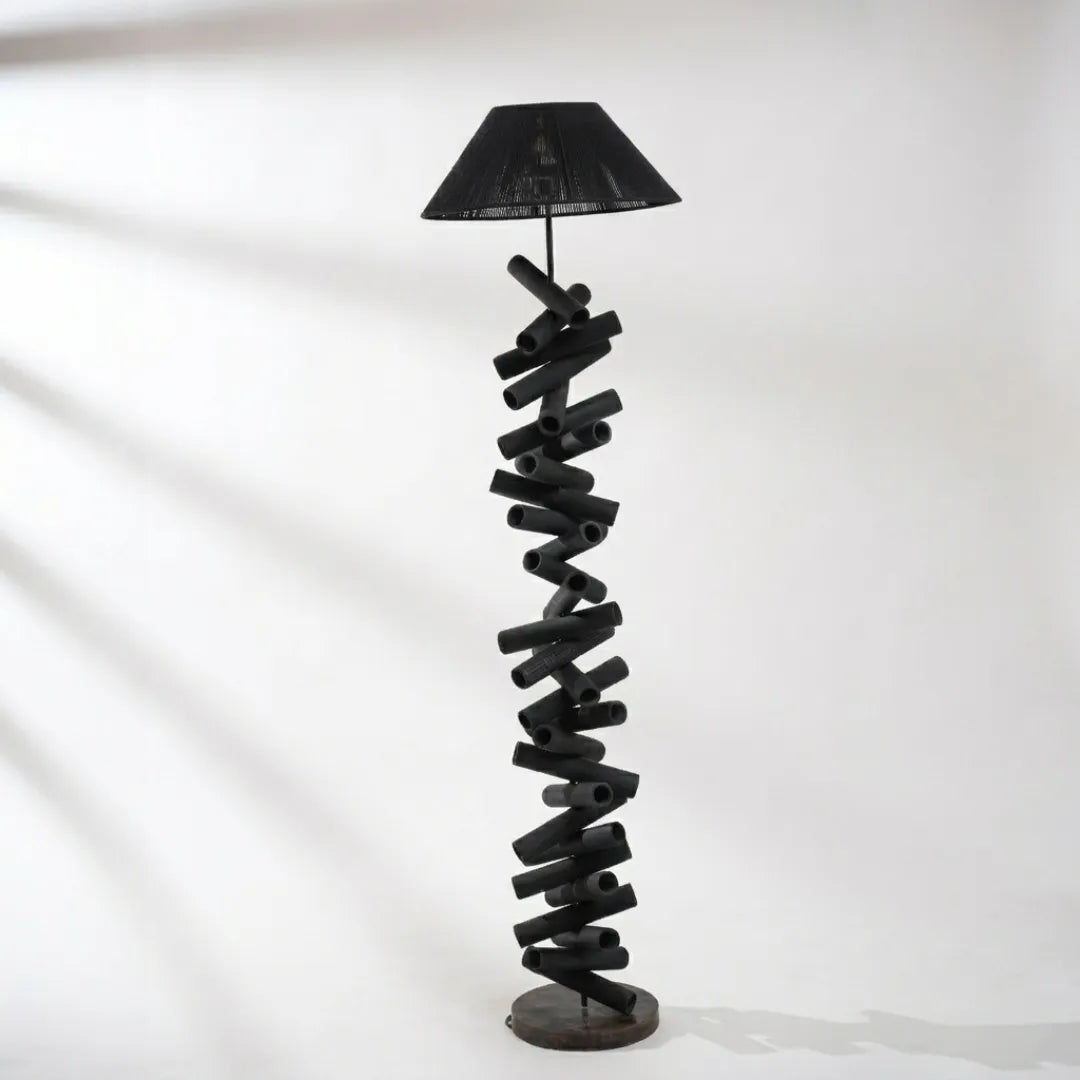 Spiral design floor lamp with black shade on a white background