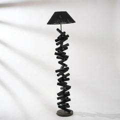 Spiral design floor lamp with black shade on a white background