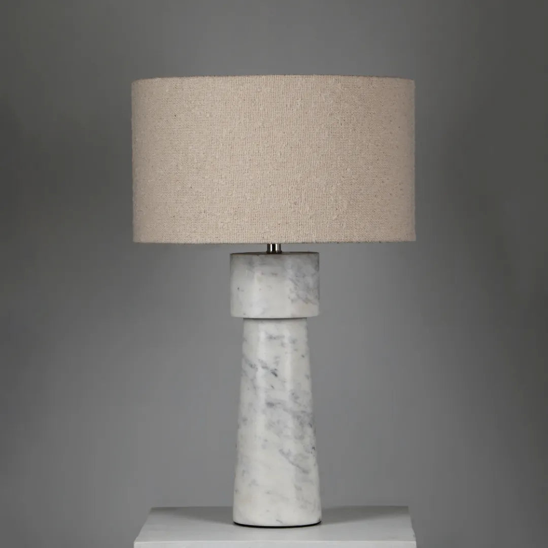 Loam Table Lamp with marble base and beige fabric shade on a gray background