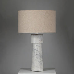 Loam Table Lamp with marble base and beige fabric shade on a gray background
