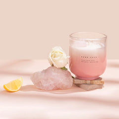Crystal Energy U-Glass Candle - Blush - Moroccan Rose, candle on stone block beside rose quartz, white rose and lemon