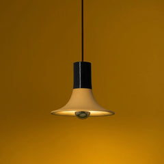 Wine Pendant Light lit, cream ceramic flared shade with glossy black neck, close-up