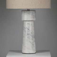Close view of Marble-textured Loam Table Lamp with a beige lampshade on a gray background