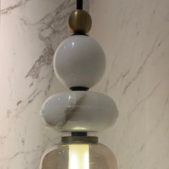 Close look of decorative pendant light with alabaster white and gold design 