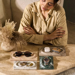 Mesa Marble Tray - Woman Seated at Table with Four Trays in Assorted Marbles