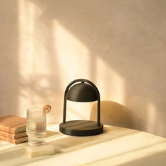 Black Mirth table lamp on a wooden surface 