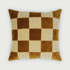Checkered pillow with brown and beige squares on a white background
