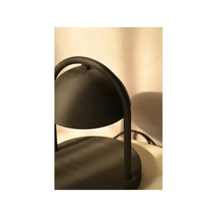 Close view of modern black mirth table lamp with a warm glow 