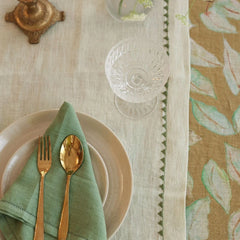 Mirage Pistachio Linen Table Runner with plate, sage napkin and gold cutlery, top view