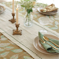 Mirage Pistachio Linen Table Runner with candles, bud vase and place setting, angled view