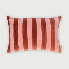 A rectangular velvet lumbar pillow with vertical stripes in dusty rose pink and dark reddish-brown, shown on a light gray background.