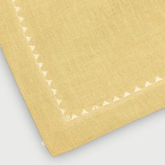 Mirage Sand Linen Table Runner close-up of embroidered triangle border at corner