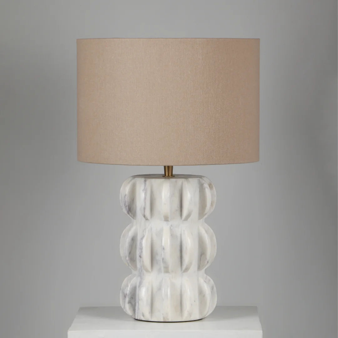 Spar Table Lamp with textured white base and beige lampshade on a gray background