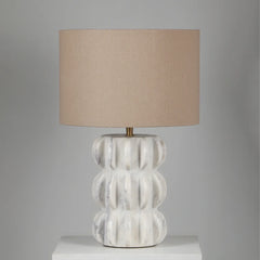Spar Table Lamp with textured white base and beige lampshade on a gray background