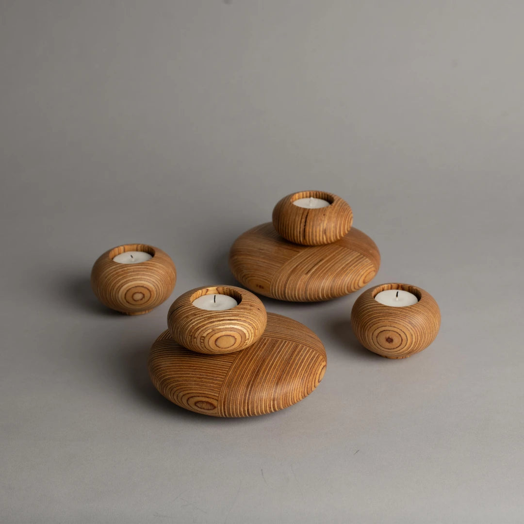Set of marine plywood candle holders on a gray background
