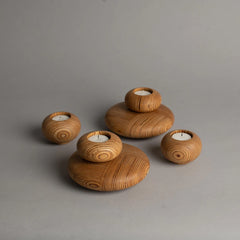 Set of marine plywood candle holders on a gray background
