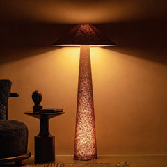 Tall Vespera Floor Lamp with a textured shade in a dimly lit room with warm lighting
