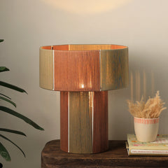 Wooden table lamp with a cotton striped design on a wooden surface.