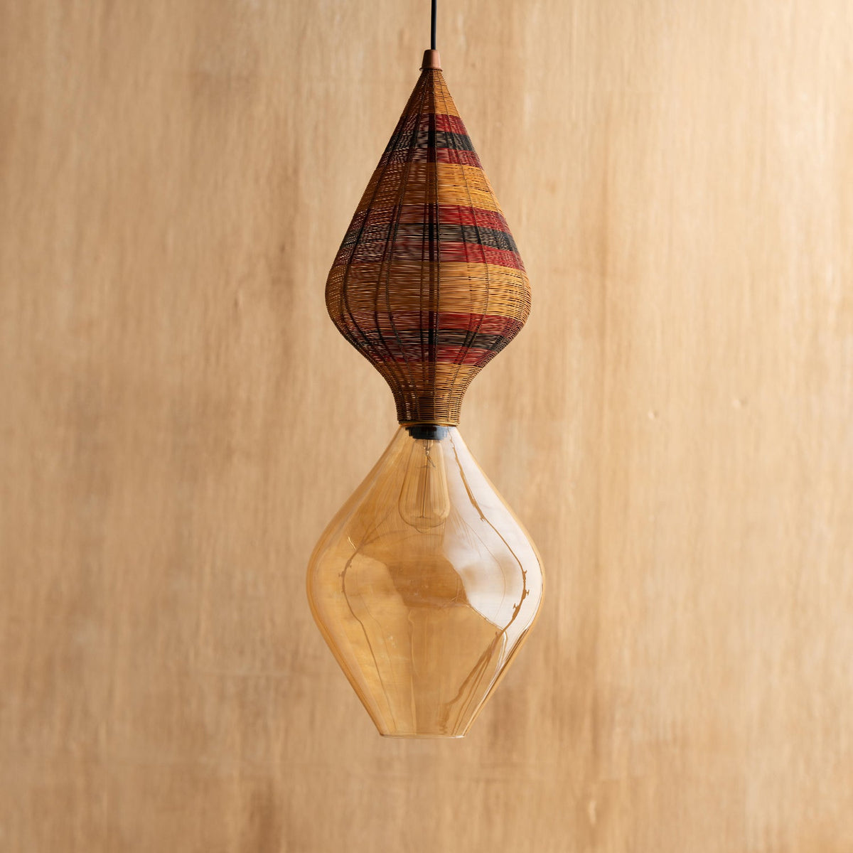 A hanging lamp with a golden brown shade, featuring a blend of traditional craftsmanship with modern elegance.