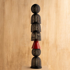 Decorative Totem Black Floor Lamp with stacked black and red geometric shapes on a wooden background