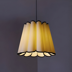Modern pendant light with multiple lampshades on a dark background