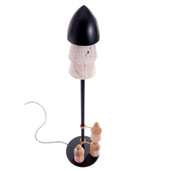 A floor lamp with a black shade and a teak wood top, featuring a lamp base with a mix of materials and a chain of wood elements extending downwards.