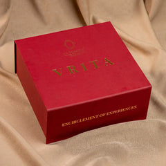 Brass bowl packing in red box with 'Vrita' branding on a beige fabric background