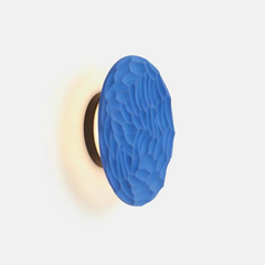 Side view of clay disc wall sconce texture