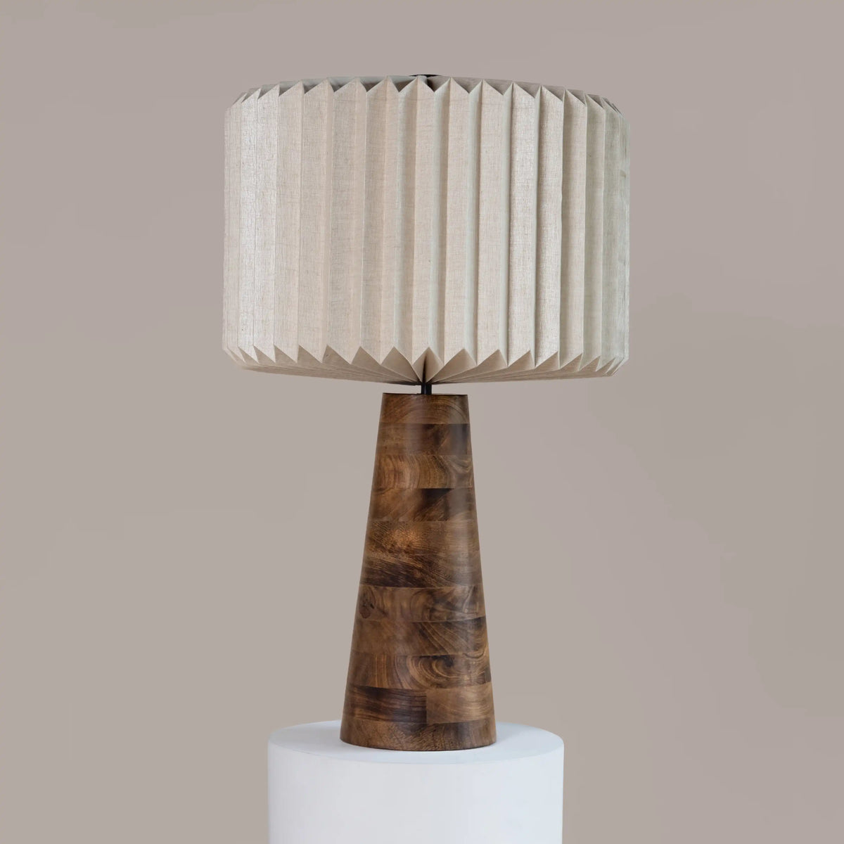 Hikari Table Lamp with wooden base and pleated beige shade on a neutral background
