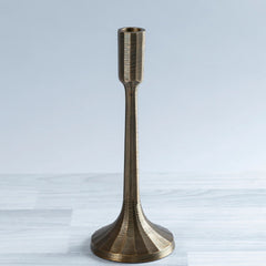 A brass plated Sanee Candle Holder with a solid pattern, featuring a vertical cylindrical shape on a flat base, placed against a neutral background.