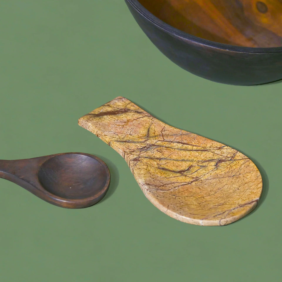 Wooden spoon placed next to a Strata Marble Spoon Rest