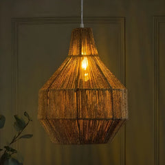 Woven Fern pendant light hanging against a dark wall