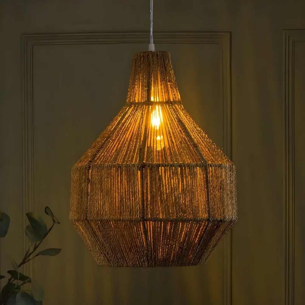 Woven Fern pendant light hanging against a dark wall