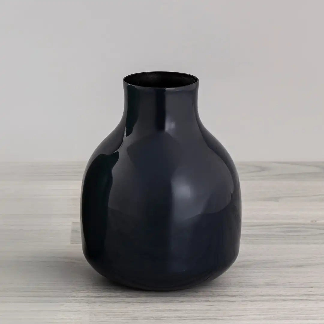 Royal blue Yodo Vase made of iron on a light wooden surface with a neutral background