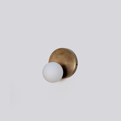 Designer Stem Wall Sconce with a glass globe shade.