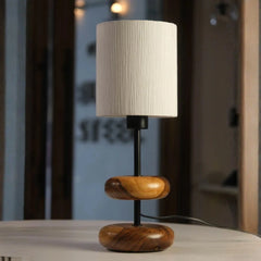 Decorative Table lamp with wooden base and beige shade on a surface