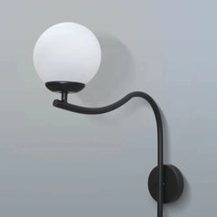 Wall-mounted Glamour Arch Wall Lamp with a white globe shade on a gray background