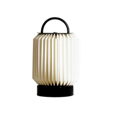 Tote Table Lamp like a foldable lantern with a black handle on a white background