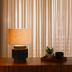 Designer Albe Table Lamp with a textured shade, illuminating warm lighting