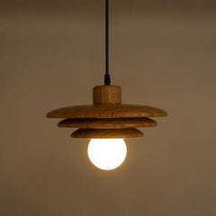 Wooden unique hanging light with a lit bulb against a beige background
