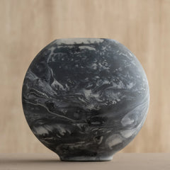 Marble-patterned Bella Black Vase on a beige background